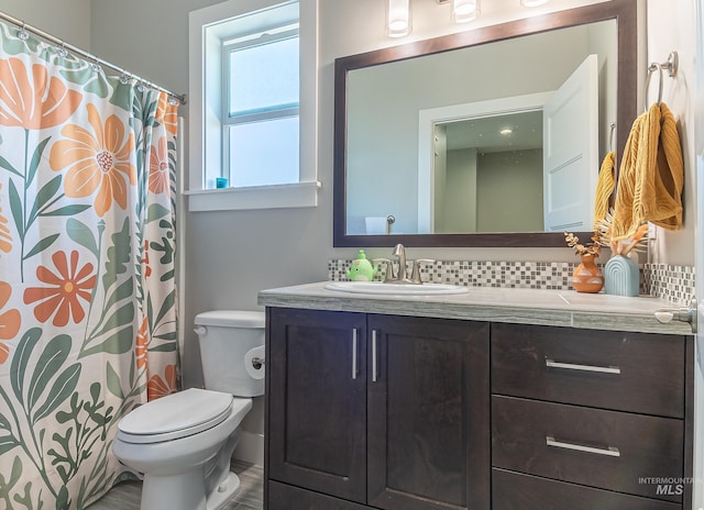 full bath featuring tasteful backsplash, toilet, and vanity