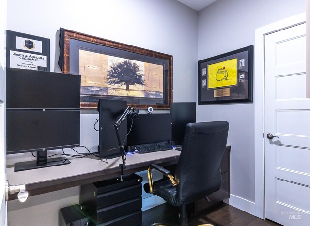 office with dark wood-style floors and baseboards