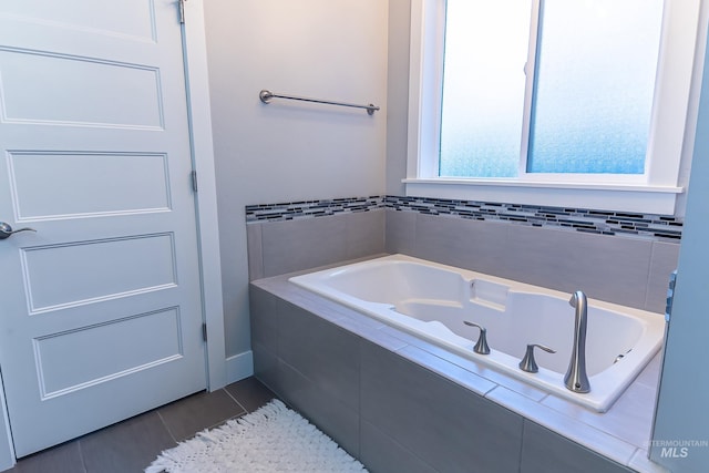 bathroom featuring tile patterned floors and a garden tub