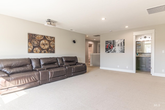 living area with visible vents, light colored carpet, and recessed lighting