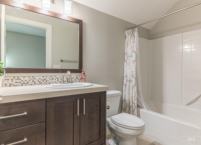 bathroom featuring vanity, decorative backsplash, toilet, vaulted ceiling, and shower / tub combo with curtain