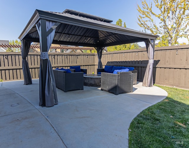 view of patio / terrace featuring an outdoor living space with a fire pit, a gazebo, and a fenced backyard