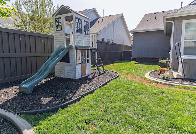 view of yard featuring a fenced backyard and a playground