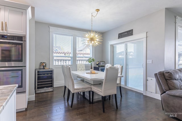 dining space featuring a wealth of natural light, wine cooler, a chandelier, and dark wood finished floors