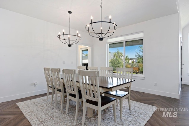 dining room featuring baseboards and a chandelier