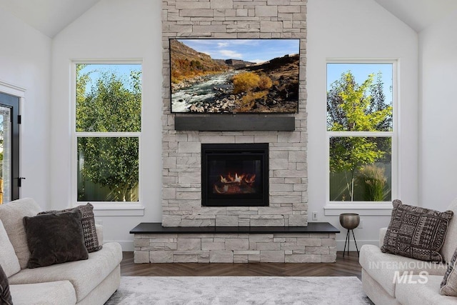 living room with lofted ceiling, wood finished floors, and a fireplace