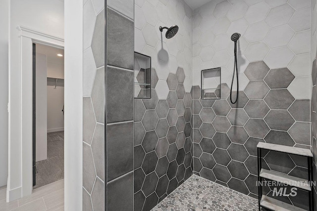 full bath featuring a tile shower