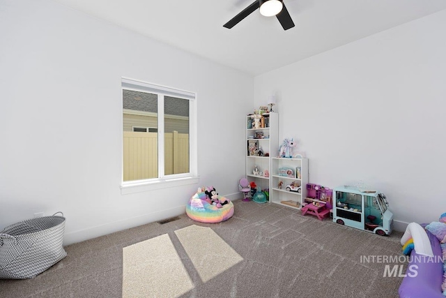 rec room with baseboards, carpet flooring, ceiling fan, and visible vents