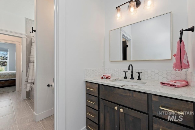 bathroom featuring a shower with curtain, vanity, and decorative backsplash