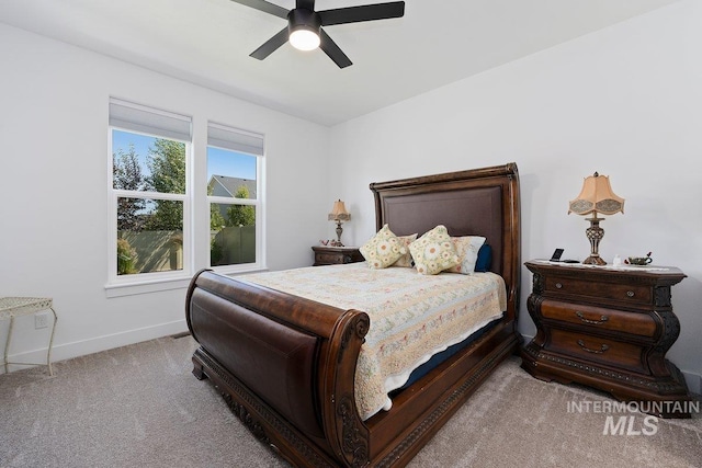 bedroom with a ceiling fan, carpet floors, and baseboards