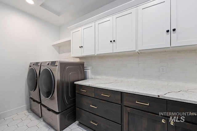 laundry room featuring recessed lighting, independent washer and dryer, baseboards, light tile patterned flooring, and cabinet space