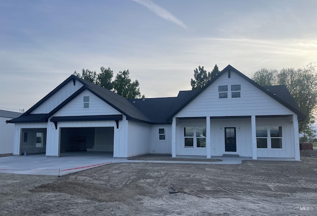 4695 County Line Rd, New Plymouth, ID 83655 - modern farmhouse style home featuring an attached garage, concrete driveway, covered porch, and board and batten siding