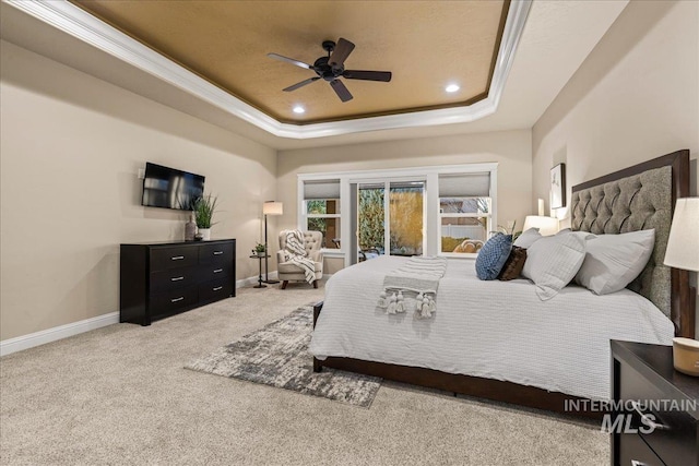 carpeted bedroom featuring recessed lighting, baseboards, a raised ceiling, and crown molding