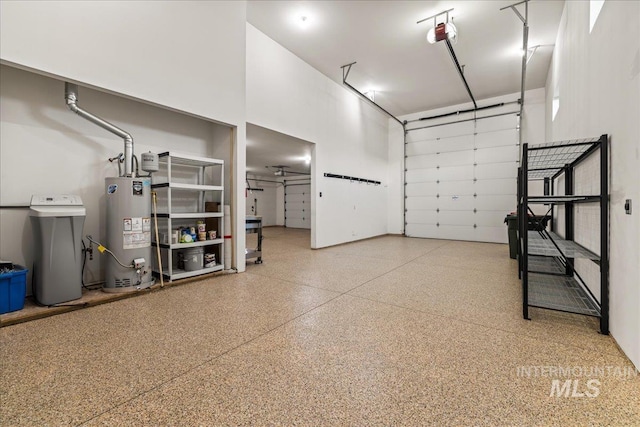 garage with a garage door opener and water heater