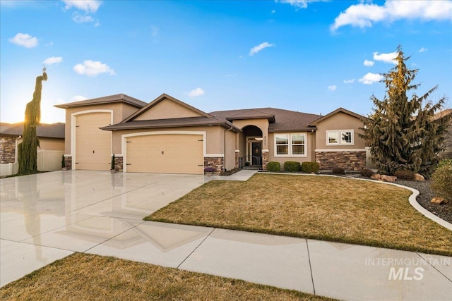 view of front of house with stucco siding, driveway, a front lawn, stone siding, and a garage