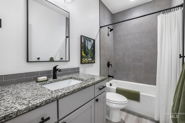 full bath featuring toilet, shower / tub combo with curtain, vanity, and visible vents