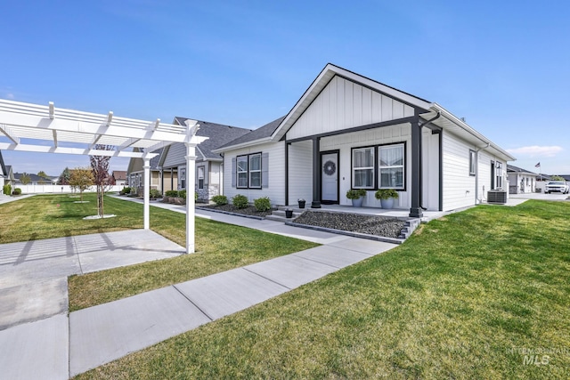 view of front of house featuring covered porch, a pergola, central air condition unit, board and batten siding, and a front yard