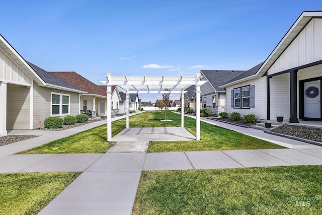 view of property's community with a pergola, a yard, and a residential view