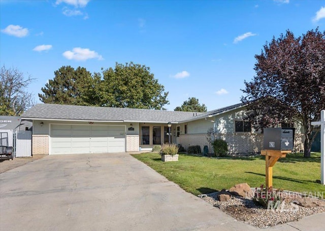 ranch-style home with a front lawn and a garage