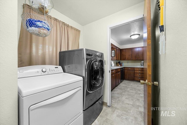 clothes washing area featuring separate washer and dryer