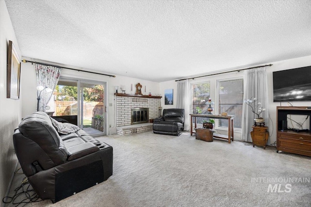 carpeted living room featuring a brick fireplace and a textured ceiling