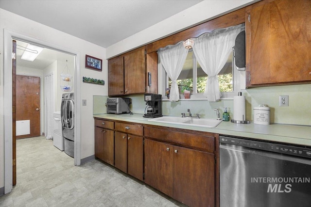 kitchen featuring sink, washer / clothes dryer, and dishwasher