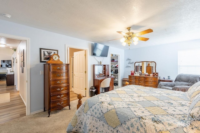 319 N Westminster St, Nampa, ID 83651 - bedroom featuring a textured ceiling, a spacious closet, a closet, light colored carpet, and a ceiling fan