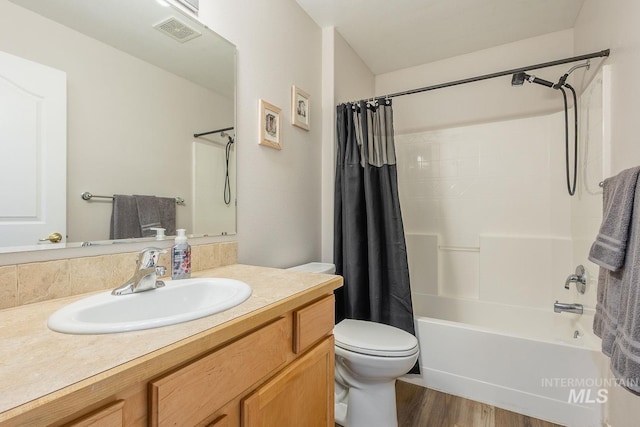 319 N Westminster St, Nampa, ID 83651 - bathroom featuring toilet, vanity, shower / bathtub combination with curtain, and wood finished floors