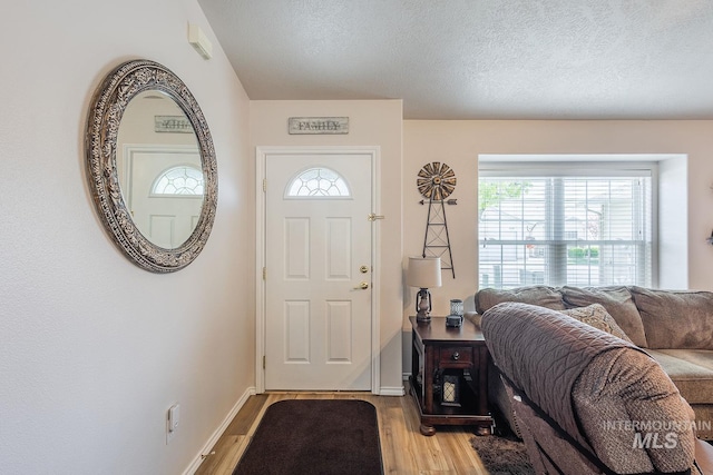 319 N Westminster St, Nampa, ID 83651 - foyer entrance with light wood-type flooring, healthy amount of natural light, a textured ceiling, and baseboards