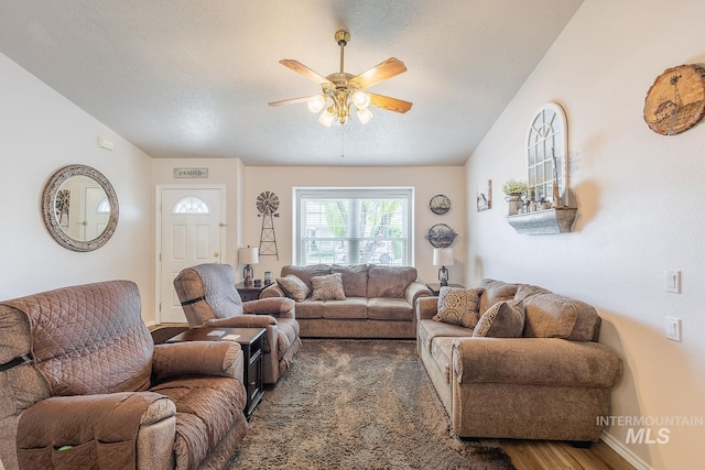 319 N Westminster St, Nampa, ID 83651 - living room featuring ceiling fan, vaulted ceiling, wood finished floors, and baseboards