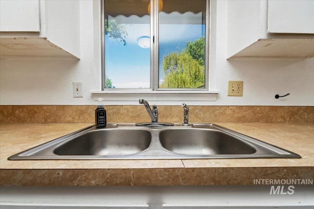 1919 S Banner St, Nampa, ID 83686 - kitchen view of a sink, white cabinets, and light countertops
