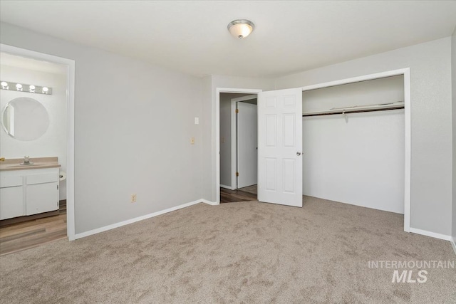 1919 S Banner St, Nampa, ID 83686 - unfurnished bedroom featuring carpet floors, a closet, connected bathroom, baseboards, and a sink