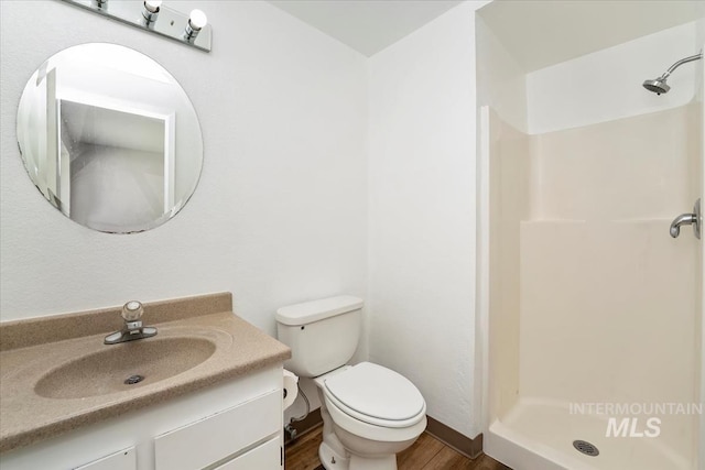 1919 S Banner St, Nampa, ID 83686 - full bath featuring a stall shower, toilet, wood finished floors, and vanity