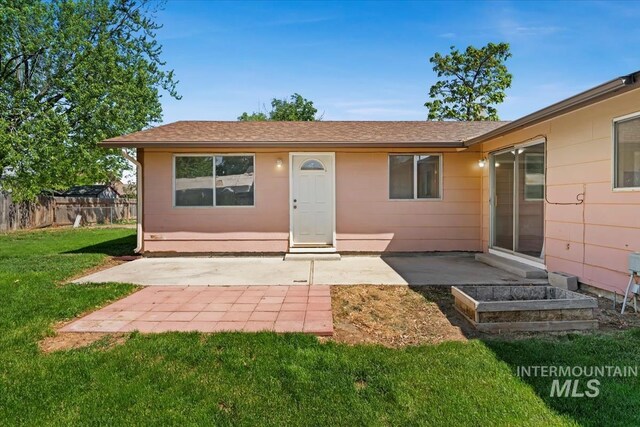 1919 S Banner St, Nampa, ID 83686 - rear view of house with a patio and roof with shingles