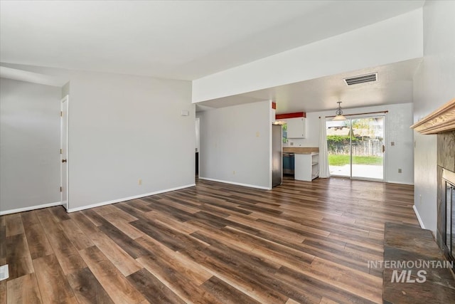 1919 S Banner St, Nampa, ID 83686 - unfurnished living room featuring a fireplace, dark wood-type flooring, and baseboards