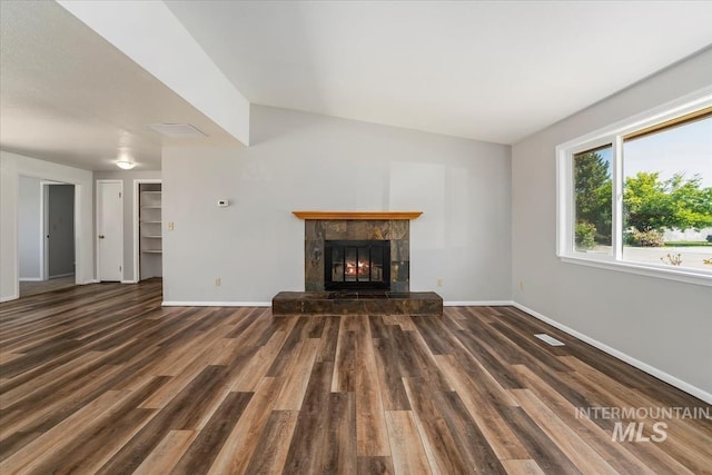 1919 S Banner St, Nampa, ID 83686 - unfurnished living room featuring baseboards, wood finished floors, a fireplace, and lofted ceiling