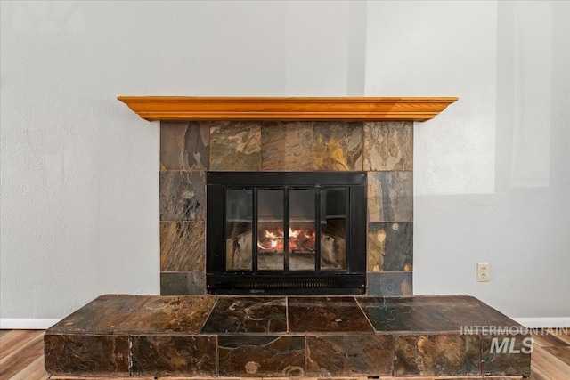 1919 S Banner St, Nampa, ID 83686 - detailed view of wood finished floors, baseboards, and a fireplace