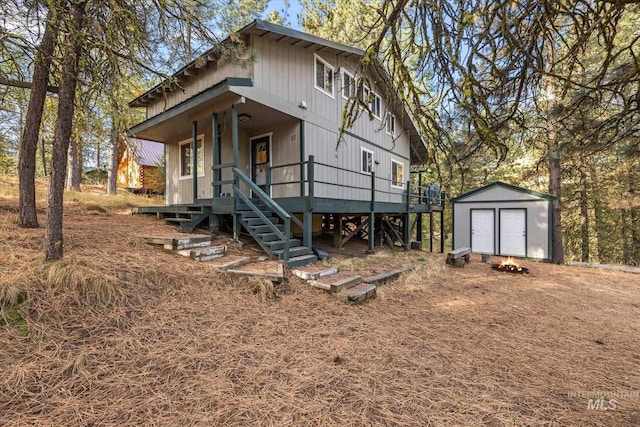 view of front of home featuring a storage shed, an outbuilding, and a porch
