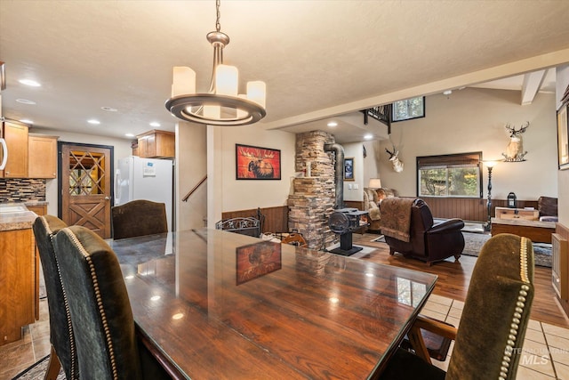 dining area with recessed lighting, decorative columns, light tile patterned flooring, and a chandelier
