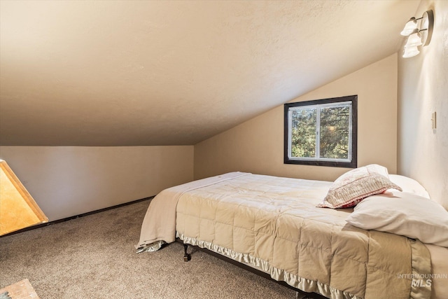 carpeted bedroom with lofted ceiling