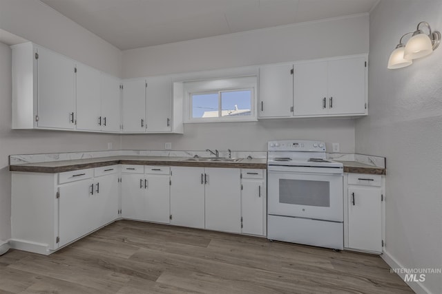 36 W Liberty, Weiser, ID 83672 - kitchen with white range with electric cooktop, white cabinets, wood finished floors, and dark countertops