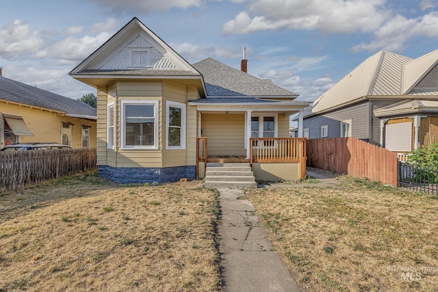 36 W Liberty, Weiser, ID 83672 - view of front facade with a porch, a chimney, and roof with shingles