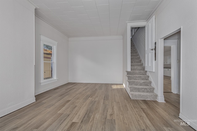 36 W Liberty, Weiser, ID 83672 - spare room with stairway, light wood-type flooring, and crown molding