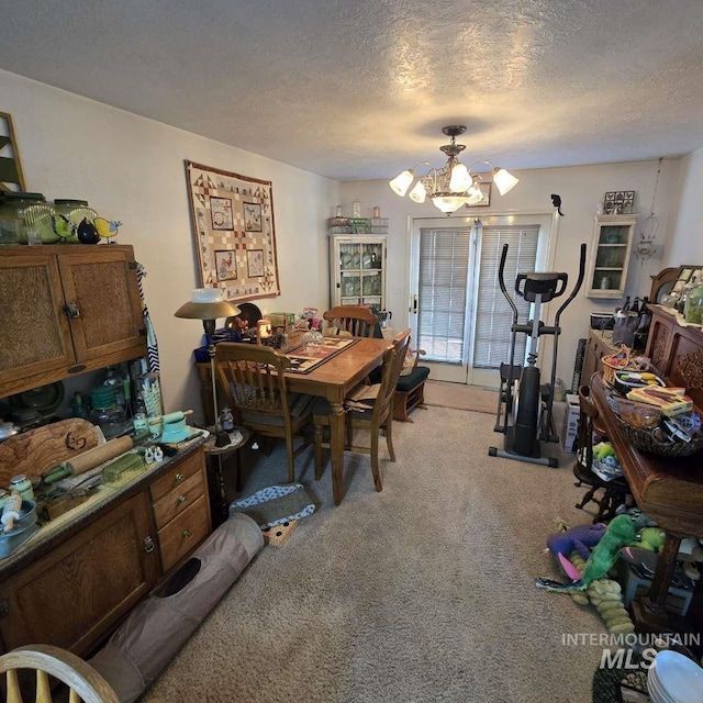 1280 Monroe Creek Rd, Weiser, ID 83672 - dining area featuring carpet floors, a chandelier, and a textured ceiling