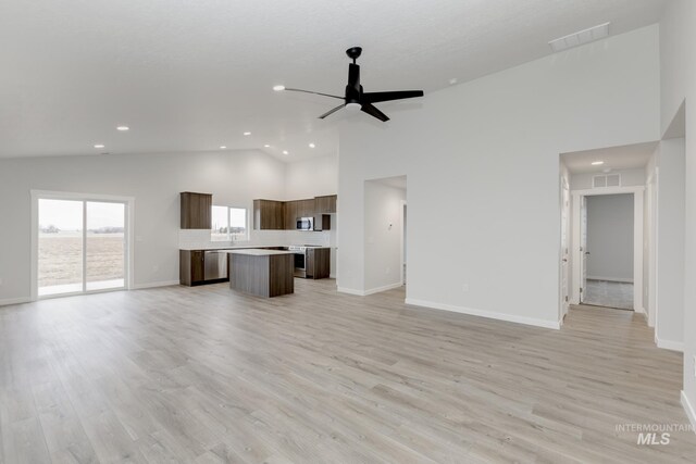 5303 E Grizzly St, Nampa, ID 83687 - unfurnished living room featuring a ceiling fan, recessed lighting, baseboards, light wood finished floors, and high vaulted ceiling