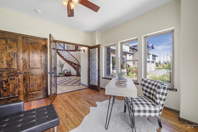 home office featuring ceiling fan and light hardwood / wood-style floors