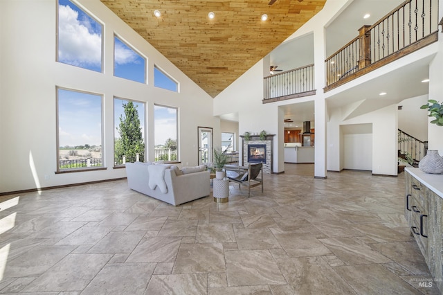 living room featuring a towering ceiling and wood ceiling
