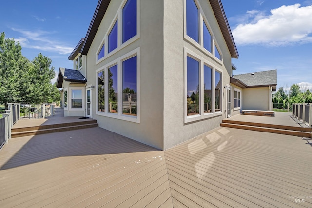 wooden deck featuring a jacuzzi