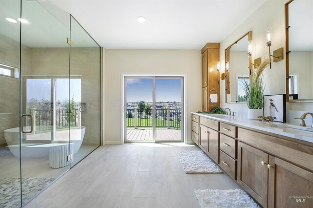 bathroom featuring vanity and a bath