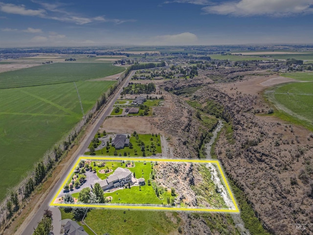 birds eye view of property with a rural view